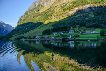 Naklejka na ściany i meble Beautiful norwegian village landscape with fjord, mountains and elegant houses in Norway