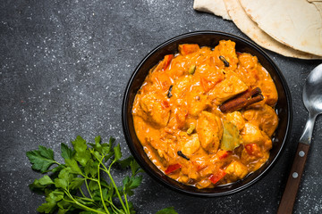 Chicken tikka masala on black top view.