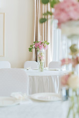 Tables set for an event party or wedding reception. luxury elegant table setting dinner in a restaurant. glasses and dishes.