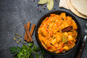 Chicken tikka masala on black top view.