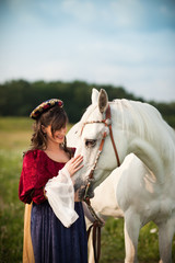 Medieval Princess with a White Horse in a Meadow