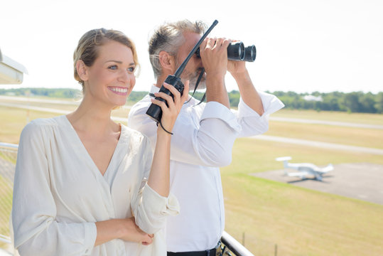 happy attractive woman using walkie-talkie