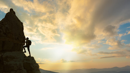 silhouette of successful climbing woman in mountains Concept of concept of motion motivation inspiration at beautiful sunset