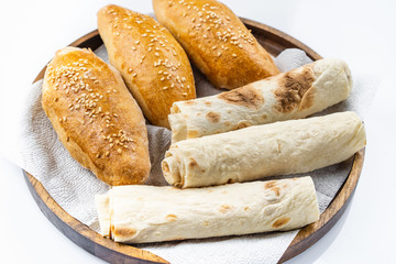 Many mixed breads and rolls shot from above.