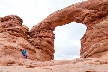 Young woman is admiring the Turret Arch in Arches National Park in Utah. Female hiker in Arches National Park. Travel and adventure concept. © blazekg