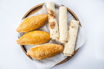 Many mixed breads and rolls shot from above.
