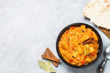 Chicken tikka masala with rice on black top view.