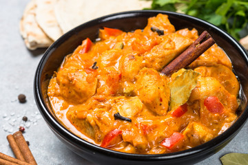 Chicken tikka masala with rice on black top view.
