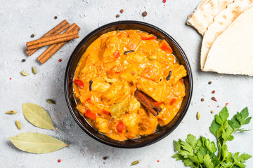 Chicken tikka masala with rice on black top view.