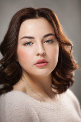 Brunette girl with day nude female face makeup.