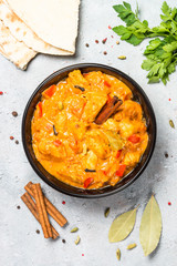 Chicken tikka masala with rice on black top view.