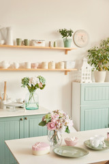 bright kitchen in the style of Provence, on the table dishes and a bouquet of flowers in a vase