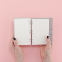 Woman hands with blank notepad mockup