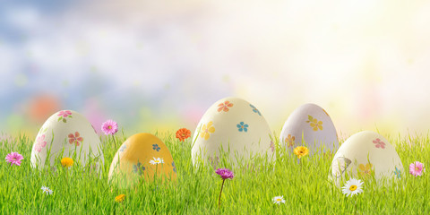 Painted eggs and flowers in grass