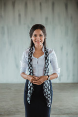 asian woman worker standing smile with scarf in the hall office look at camera