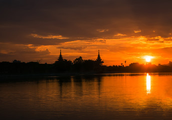  yellow and orange sky above it with  sun golden  . Amazing summer sunset view with beautiful Temple of Thailand.