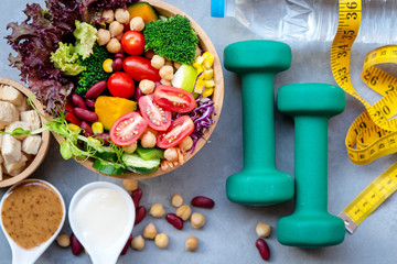 Fresh vegetable salad and healthy food for sport equipment for women diet slimming with measure tap...