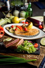 Grilled salmon steak. Fried vegetables: zucchini, tomato, eggplant, onion, pepper
