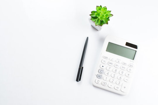 Top view of the business calculator on a white table. Business concept.