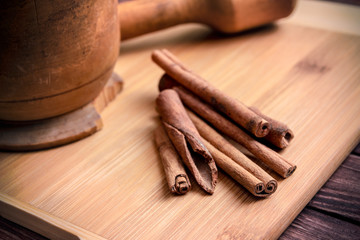 Cinnamon sticks on vintage wooden background
