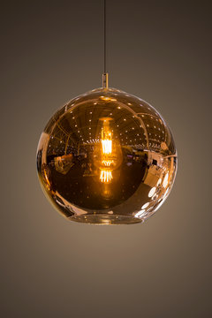 Modern Streamlined Mirror Round Copper Chandelier. Bubble Glass Transparent Pendant Light. Isolate On Dark Background