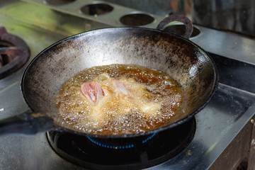 Fried chicken in hot oil and boiling in pan