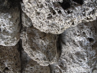 Texture. Wall of brick made of grey porous stone