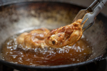 Fried chicken in hot oil and boiling in pan
