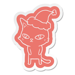 cartoon  sticker of a cat with bright eyes wearing santa hat