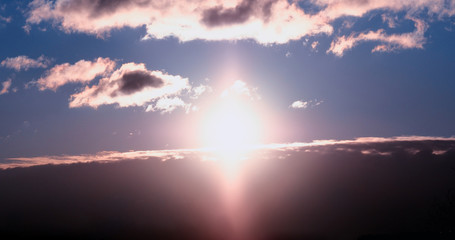 Dramatic atmospheric front of clouds during burning sunset background