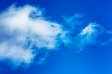 Naklejka na ściany i meble Bright blue sky with big cloud, background
