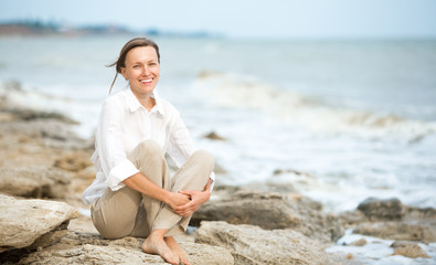 Fototapeta na wymiar Young woman enjoying life on the ocean coast