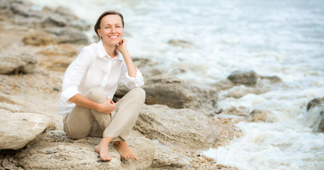 Young woman enjoying life on the ocean coast