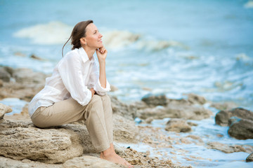 Young woman enjoying life on the ocean coast