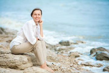 Young woman enjoying life on the ocean coast