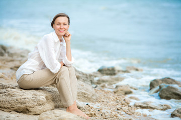 Fototapeta na wymiar Young woman enjoying life on the ocean coast