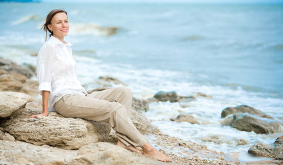 Young woman enjoying life on the ocean coast