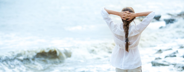 Young woman enjoying life on the ocean coast