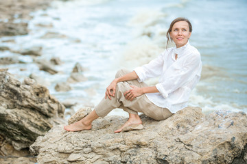 Young woman enjoying life on the ocean coast