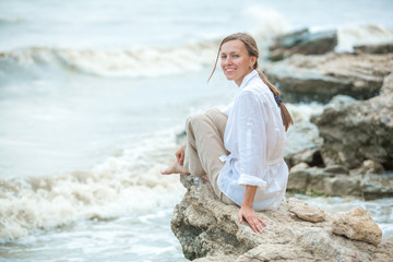Young woman enjoying life on the ocean coast