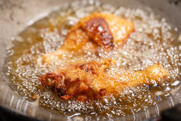 Fry the chicken in a pan with boiling oil.