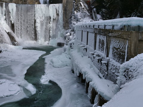 old hydro dam in the winter with waterfalls