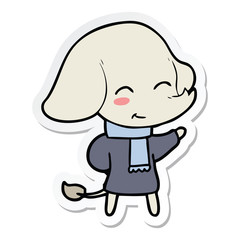 sticker of a cute cartoon elephant in winter clothes