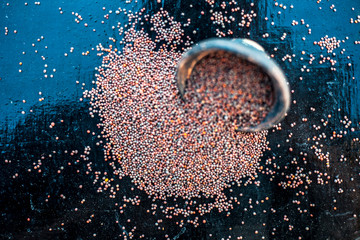 Raw organic herbal spice Mustard seeds or sarso or rai or Brassica nigra, in a clay bowl on wooden surface. - obrazy, fototapety, plakaty