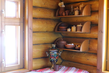 Part of the interior of the premises of a rustic log house.