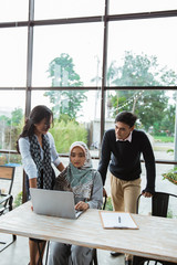 Fototapeta premium mentoring female employees by more experienced department head witnessed by CEO of the company