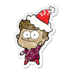distressed sticker cartoon of a happy man wearing santa hat