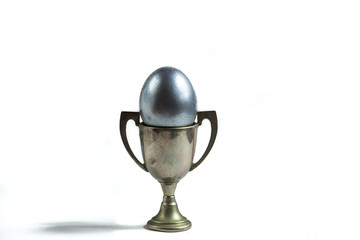 silver egg on a silver trophy isolated on white