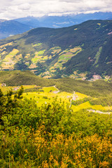 Obraz premium Alpe di Siusi, Seiser Alm with Sassolungo Langkofel Dolomite, a large green field with a mountain in the background