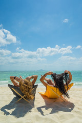 Two Women enjoying their holidays on the tropical beach